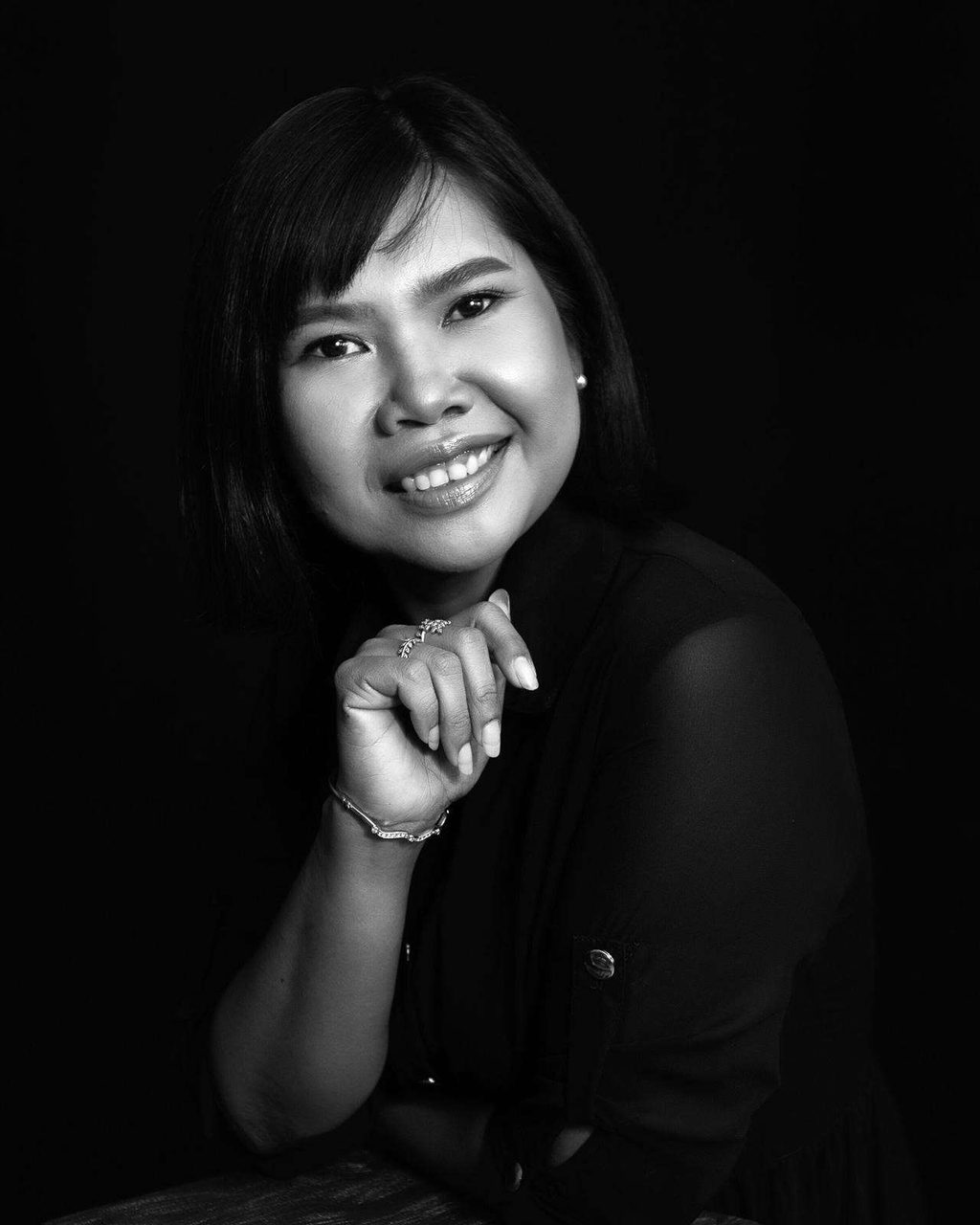 Black-and-white editorial portrait of Supparin Luenkaew, lead floral designer at Wedding Flowers Phuket