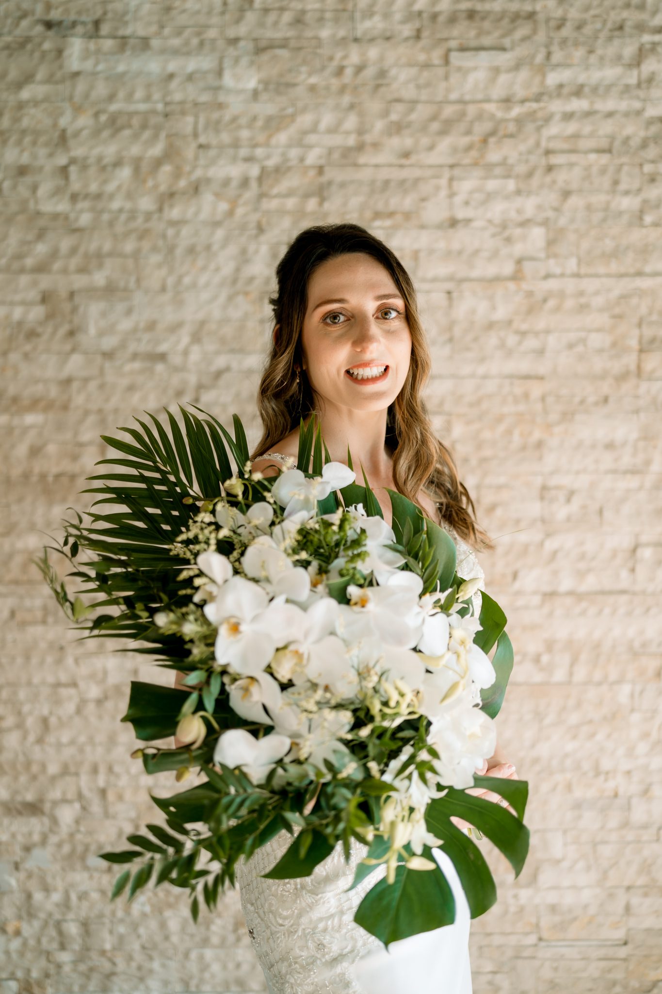 Bride at Villa Satis holding a white garden-rose bridal bouquet, by Wedding Flowers Phuket
