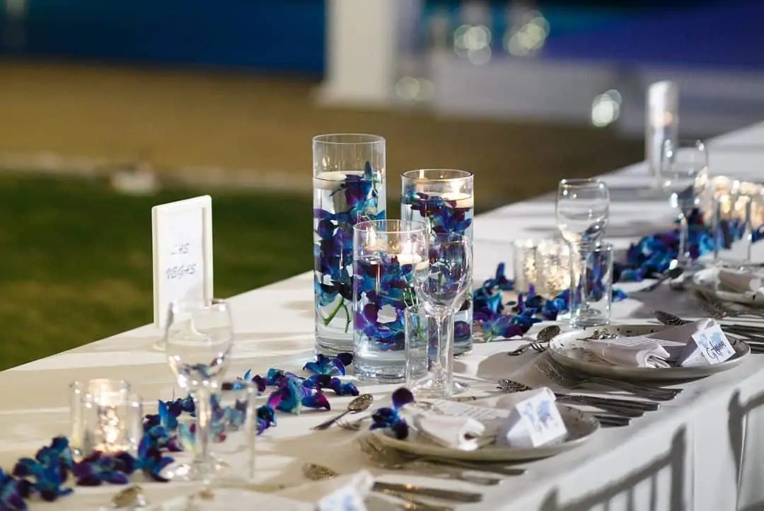 Reception floral detail — candle, stem and tabletop layer designed by Wedding Flowers Phuket