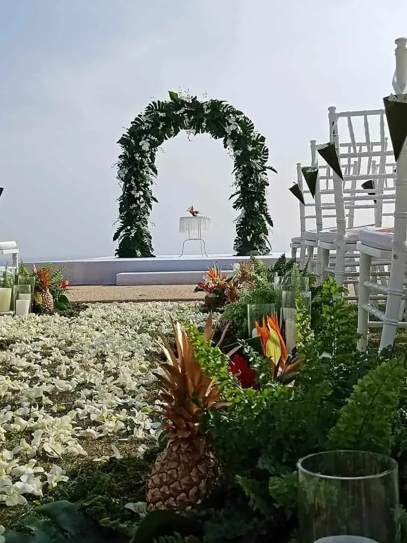 Tropical foliage arch with bird-of-paradise and a gilded pineapple aisle, Phuket, by Wedding Flowers Phuket